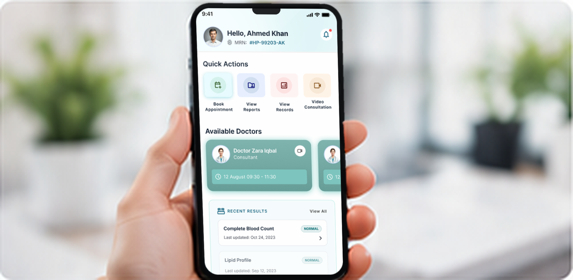 Hand holding a phone that shows the patient app home screen